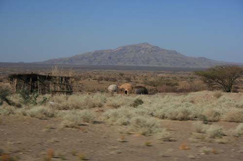 Desert landscape with a volcano and traditional building
